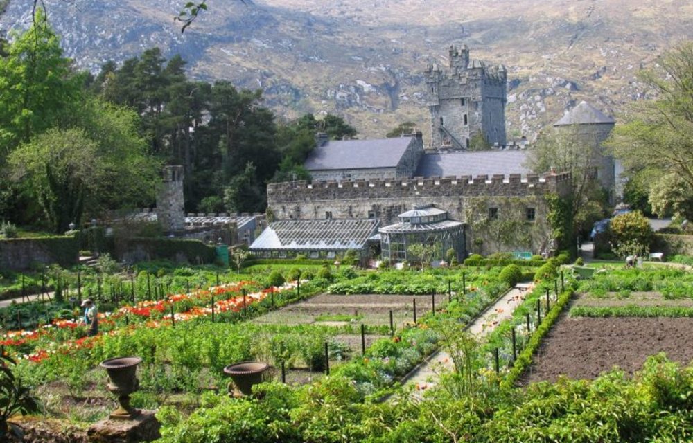 The image shows a view of Glenveagh Castle taken from above the walled vegetable garden.
